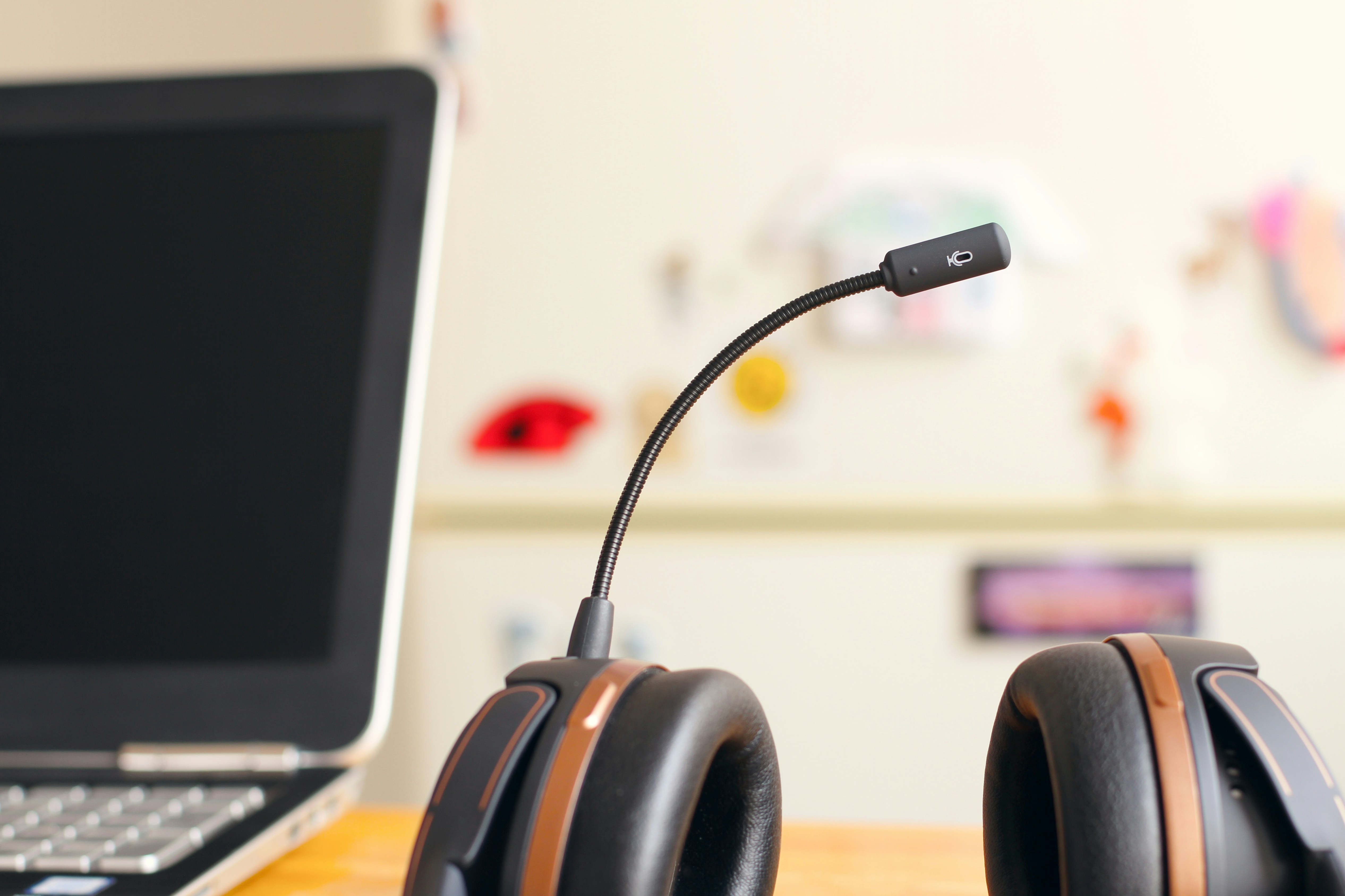 closeup of headset with laptop in the background